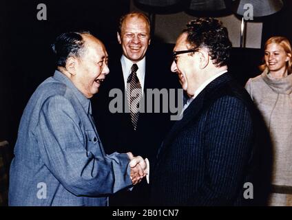 China/USA: Chairman Mao Zedong shaking hands with Henry Kissinger as President Gerald Ford and his daughter Susan Ford look on, Beijing, 2 December 1975  Kissinger served as National Security Advisor and later concurrently as Secretary of State in the administrations of Presidents Richard Nixon and Gerald Ford. After his term, his opinion was still sought by many following presidents and world leaders.  A proponent of Realpolitik, Kissinger played a dominant role in United States foreign policy between 1969 and 1977. During this period, he pioneered the policy of détente with the Soviet Union. Stock Photo