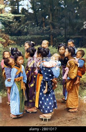 Japan: A group of Japanese children in traditional dress, c. 1922.   The various traditional ethnic garments worn in Japan are still in use, mainly worn for ceremonies and special occasions, like weddings or festivals. Today both men and women favour 'western-style' clothing in their daily lives, due to the comparative convenience and the influx of global fashion.  Japanese clothing is styled to fit the seasons. Clothing with more rustic colours and patterns (like russet leaves) are favoured in autumn, while in spring more vibrant colours and floral designs (like cherry blossoms) are common. Stock Photo