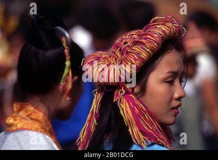 Thailand: Lisu women dress up in fine headdresses for Lisu New Year celebrations, Chiang Mai Province, northern Thailand.  he Lisu people (Lìsù zú) are a Tibeto-Burman ethnic group who inhabit the mountainous regions of Burma (Myanmar), Southwest China, Thailand, and the Indian state of Arunachal Pradesh.  About 730,000 live in Lijiang, Baoshan, Nujiang, Diqing and Dehong prefectures in Yunnan Province, China. The Lisu form one of the 56 ethnic groups officially recognised by the People's Republic of China. In Burma, the Lisu are known as one of the seven Kachin minority groups. Stock Photo
