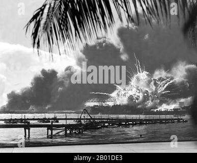 USA/Japan: The USS Shaw exploding during the Japanese attack on Pearl Harbour, December 7, 1941.  The attack on Pearl Harbor was a surprise military strike conducted by the Imperial Japanese Navy against the United States naval base at Pearl Harbor, Hawaii, on the morning of December 7, 1941 (December 8 in Japan).  The attack was intended as a preventive action in order to keep the U.S. Pacific Fleet from interfering with military actions the Empire of Japan was planning in Southeast Asia against overseas territories of the United Kingdom, the Netherlands, and the United States. Stock Photo
