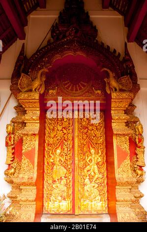 Thailand: Front doors to the viharn at Wat Phuak Hong show figures in the form of the Hindu god Vishnu, Chiang Mai.  Wat Phuak Hong (วัดพวกหงษ์), the 'Temple of the Flight of Swans', is located in the southwest corner of Chiang Mai Old City. A typical small Lan Na temple, it is chiefly notable for the round stupa that stands to the west of the viharn. Built in the 16th century, the rounded structure has seven diminishing tiers encircled by a total of 52 niches for images of the Buddha,some of which survive today, though in a rather damaged condition. Stock Photo