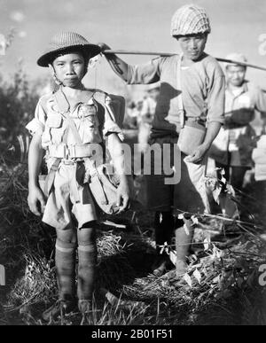 Burma/Myanmar: Chinese child soldier on the China-Burma-India Theatre at Myitkyina, May 1944.  This Chinese child soldier, age 10, with heavy pack, was a member of an army division boarding a plane returning them to China, following the capture of Myitkyina airfield, Burma, under the allied command of US Major General Frank Merrill.  Chinese and allied troops had earlier crossed through the treacherous jungle of the Kumon Bum Mountains before attacking Japanese troops to the south. Exhaustion and disease led to the early evacuation of many Chinese and allied troops before the coming assault. Stock Photo