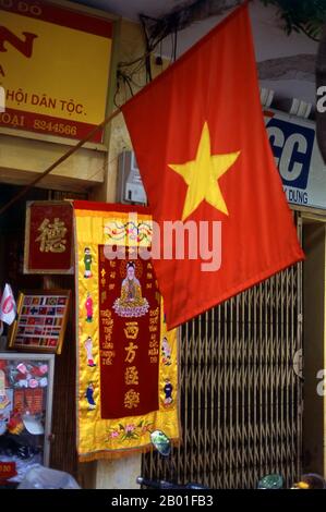 Vietnam: Flag and poster shop in the Old Quarter, Hanoi.  Hanoi's Old Quarter lies immediately north of Ho Hoan Kiem lake. It's better known locally as Bam Sau Pho Phuong or the ‘Thirty Six Streets’. 'Phuong' means a trade guild, and most of the streets begin with the word 'hang' meaning merchandise. This ancient section of the city has long been associated with commerce, and it remains very much so today. Stock Photo