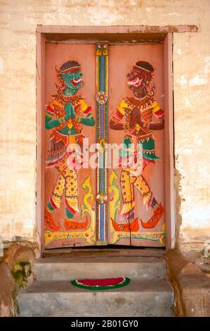 Thailand: Painted guardian figures on the doors of the old viharn at Wat Si Pho Chai Na Phung, Na Haeo District, Loei Province.  Loei (Thai: เลย) Province is located in Thailand's upper North-East. Neighboring provinces are (from east clockwise) Nong Khai, Udon Thani, Nongbua Lamphu, Khon Kaen, Phetchabun, Phitsanulok. In the north it borders Xaignabouli and Vientiane Provinces of Laos.<  The province is covered with low mountains, while the capital Loei is located in a fertile basin. The Loei River, which flows through the province, is a tributary of the Mekong. Stock Photo