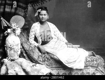 Burma/Myanmar: Studio portrait by Philip Adolphe Klier (1845 - 27 March 1911) of a young Burman woman with a cheroot, probably Rangoon/Yangon, 1895.  Philip Adolphe Klier was a German photographer best known for his photographs of colonial Burma / Myanmar. By 1871 he was a professional photographer in Moulmein, Burma. His business included work as an optician, watchmaker and jeweller as well running the firm known as Murken & Klier.  Around 1880 Klier moved to Rangoon, Burma‘s largest city, which had become the centre of Indo-British power since the conquest of the Irrawaddy Delta in 1852. Stock Photo