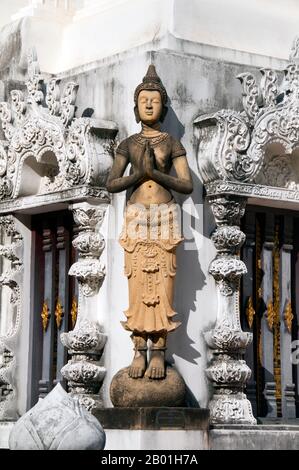 Thailand: Sculpture of a thewada (angel), Wat Nantaram, Chiang Mai.  Deva is the Hindu term for deity; devatas (Thai: thewada) are a kind of smaller more focused devas, the equivalent of guardian spirits or guardian angels. There are male and female devata. In Hinduism, the devatas that guard the nine cardinal points are called Devata Lokapala (Guardians of the Directions) or in ancient Java called Dewata Nawa Sanga (Nine guardian gods). Each caste has its guardian deva, and every human activity has its devata, its spiritual counterpart or aspect. Stock Photo