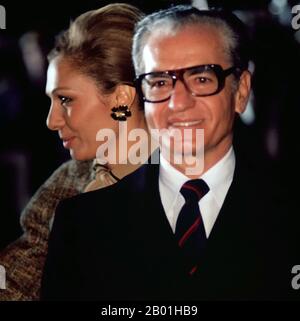 Iran/Persia/USA: Mohammed Reza Pahlavi (26 October 1919 – 27 July 1980) and his wife, Empress Farah, departing the United States after a visit on 16 November 1977.  Mohammad Rezā Shāh Pahlavi, Shah of Iran, Shah of Persia, ruled Iran from 16 September 1941 until his overthrow by the Iranian Revolution on 11 February 1979. He was the second and last monarch of the House of Pahlavi of the Iranian monarchy. He came to power during World War II after an Anglo-Soviet invasion forced the abdication of his father Reza Shah. During his reign, the Iranian oil industry was nationalised. Stock Photo