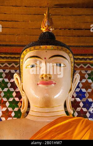 Thailand: Buddha within the viharn at Wat Nong Kham (Pa O temple), Chiang Mai.  The Pa-Oh, also known as Taungthu and Black Karen, are an ethnic group in Burma, comprising approximately 600,000. They form the second largest ethnic group in Shan State, and are believed to be of Tibeto-Burman stock. They are ethnolinguistically related to the Karen and populate Shan State, Kayin State and Kayah State.  King Mengrai founded the city of Chiang Mai (meaning 'new city') in 1296 and it succeeded Chiang Rai as capital of the Lanna kingdom. Chiang Mai is sometimes written as 'Chiengmai' or 'Chiangmai'. Stock Photo