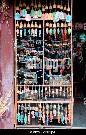 China: Handicraft shop, Lijiang Old Town, Yunnan Province.  The Naxi or Nakhi are an ethnic group inhabiting the foothills of the Himalayas in the northwestern part of Yunnan Province, as well as the southwestern part of Sichuan Province in China. The Naxi are thought to have come originally from Tibet and, until recently, maintained overland trading links with Lhasa and India.  The Naxi form one of the 56 ethnic groups officially recognised by the People's Republic of China. The Naxi are traditionally followers of the Dongba religion. Stock Photo