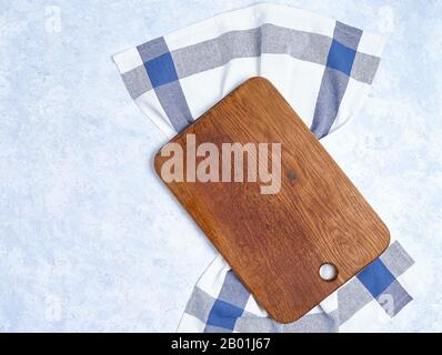 beautiful wooden kitchen background cutting board over kitchen towel on white background Stock Photo