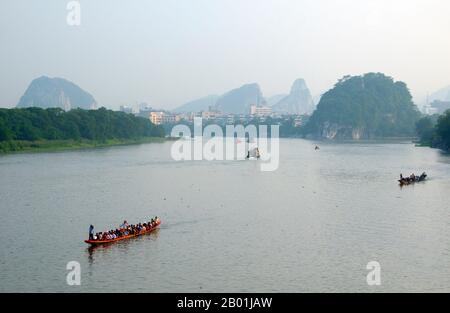 China: Dragon boats on the Li River, Guilin, Guangxi Province.  Guilin's Dragon Boat Festival is held on the fifth day of the fifth month (May) of the Chinese lunar calendar every 3 years. The festival was originally held in memory of the great Chinese poet, Quyuan.  The name Guilin means ‘Cassia Woods’ and is named after the osmanthus (cassia) blossoms that bloom throughout the autumn period.  Guilin is the scene of China’s most famous landscapes, inspiring thousands of paintings over many centuries. Stock Photo
