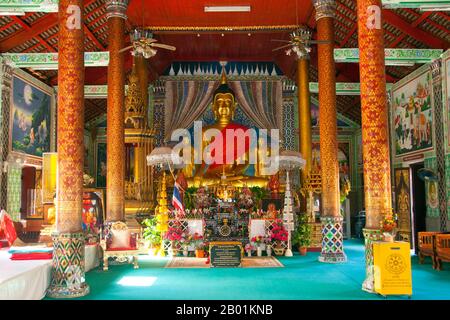 Thailand: Buddha image in the main viharn, Wat Chedi Sao, Lampang, Lampang Province.  Wat Chedi Sao or 'The Monastery of Twenty Chedis' is famed for its 20 whitewashed chedis, which are a mix of Burmese and Lanna design. The temple also contains a Chiang Saen-style Buddha referred to locally as Phra Chao Than Chai. The image stands only 38 cm tall, but weighs a staggering 150 kg.  Lampang was originally founded during the 7th century Dvaravati period. Nothing remains from these early times, but the city is rich in temples, many of which have a distinctly Burmese flavour. Stock Photo