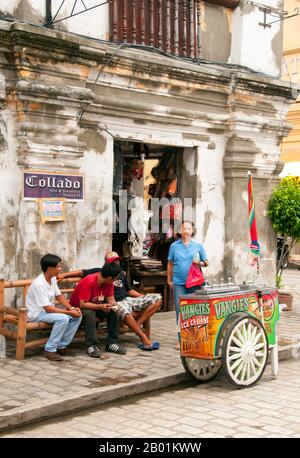 Philippines: Ice cream cart, Mestizo District, Vigan, Ilocos Sur Province, Luzon Island.  The City of Vigan is the capital of the Province of Ilocos Sur and located on the western coast of the island of Luzon.  Vigan is the only surviving historic city in the Philippines that dates back to the 15th century Spanish colonial period. The town was also an important trading post in pre-colonial times with a community of Chinese traders from Fujian settled in the area.  Today it has been awarded UNESCO World Heritage Site status. Stock Photo