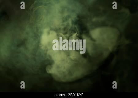 Blurred, mint green, wisp of smoke from burning incense. Fuzzy looking soft background texture image. Stock Photo