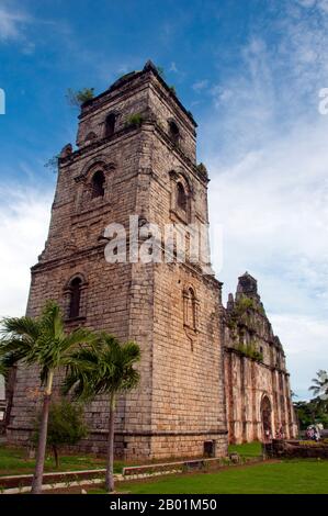 Philippines: Bell tower, San Agustin (St. Augustine) Catholic Church, Paoay, Ilocos Norte, Luzon Island.  The earliest historical record of the Paoay area dates back to 1593, becoming an Augustinian independent parish in 1686. Building of the present church was started in 1694 by Augustinian friar Father Antonio Estavillo, and it was completed in 1710. The church is famous for its distinct architecture highlighted by the enormous buttresses on the sides and back of the building. Stock Photo