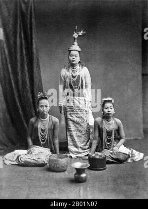 Burma/Myanmar: Studio portrait of a professional group of Bamar dancers, c. 1870s.  The British conquest of Burma began in 1824 in response to a Burmese attempt to invade India. By 1886, and after two further wars, Britain had incorporated the entire country into the British Raj. To stimulate trade and facilitate changes, the British brought in Indians and Chinese, who quickly displaced the Burmese in urban areas. To this day Rangoon and Mandalay have large ethnic Indian populations. Railways and schools were built, as well as a large number of prisons, including the infamous Insein Prison. Stock Photo