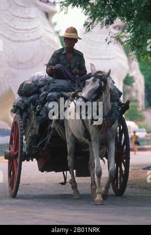 Burma/Myanmar: Charcoal seller with his horse and cart, Mandalay.  Mandalay, a sprawling city of more than 1 million people, was founded in 1857 by King Mindon to coincide with an ancient Buddhist prophecy. It was believed that Gautama Buddha visited the sacred mount of Mandalay Hill with his disciple Ananda, and proclaimed that on the 2,400th anniversary of his death, a metropolis of Buddhist teaching would be founded at the foot of the hill. Stock Photo