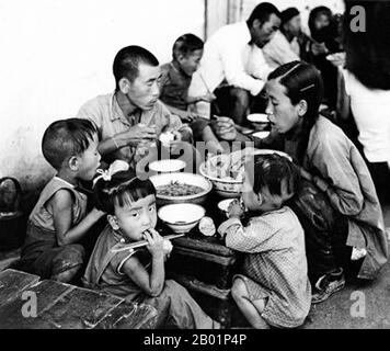 China: Peasant families eating at a commune during the Great Leap Forward (1958-1961).  The Great Leap Forward of the People's Republic of China (PRC) was an economic and social campaign of the Communist Party of China (CPC), reflected in planning decisions from 1958 to 1961, which aimed to use China's vast population to rapidly transform the country from an agrarian economy into a modern communist society through the process of rapid industrialisation, and collectivisation. Mao Zedong led the campaign based on the Theory of Productive Forces. Stock Photo