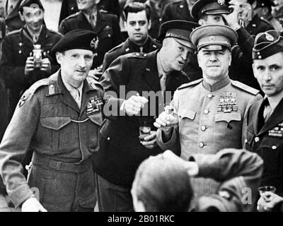 Russia/Germany: Marshal Georgy Zhukov (1868-1974) with General Dwight Eisenhower (1890-1969) and Field Marshal Bernard Montgomery (1887-1976), toasting victory in Frankfurt, 16 June 1945.  Marshal of the Soviet Union Georgy Konstantinovich Zhukov was a Russian career officer in the Red Army who, in the course of World War II, played a pivotal role in leading the Red Army through much of Eastern Europe to liberate the Soviet Union and other nations from the Axis Powers' occupation and conquer Germany's capital, Berlin. He is the most decorated general in the history of Russia and the USSR. Stock Photo