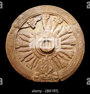 Thailand: Mon era dharmacakra or Buddhist 'Wheel of Law', Dvaravati, c. 8th century CE. Photo by Jean-Pierre Dalbéra (CC BY-3.0 License).  The Dvaravati/Thawarawadi period lasted from the 6th to the 13th centuries. Dvaravati refers to both a culture and a disparate conglomerate of principalities.  By the 10th century, Dvaravati began to come under the influence of the Khmer Empire and central Thailand was ultimately invaded by the Khmer king Suryavarman II in the first half of the 12th century. Haripunchai survived its southern progenitors until the late 13th century CE. Stock Photo