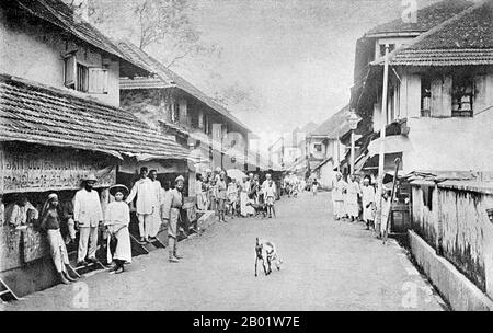 India: A street scene in Cochin (Kochi) , Kerala. Photo by Charley Brown, c. 1913.  Kochi, formerly Cochin, is a major port city on the west coast of India by the Arabian Sea.  In 1866, Fort Kochi became a municipality, and its first Municipal Council election was conducted in 1883. The Maharaja of Cochin, who ruled under the British, in 1896 initiated local administration by forming town councils in Mattancherry and Ernakulam. In 1925, Kochi legislative assembly was constituted due to public pressure on the state. Stock Photo