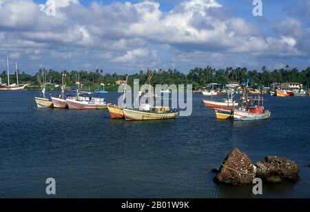 Sri Lanka: Fishing boats in the harbour at Beruwala, Western Province.  The name Beruwala is derived from the Sinhalese word for the place where the sail is lowered. It marks the spot of the first Muslim settlement on the island, established by Arab traders around the 8th century CE. A large population of Sri Lankan Moors, many of them gem merchants, still live in the town - particularly in the 'China Fort'. Msjid-ul-Abrar, a landmark of Beruwala and Sri Lanka's oldest mosque, was built by Arab traders on a rocky peninsula overlooking the town. Stock Photo