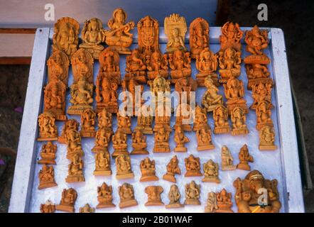India: Sandalwood carvings of Hindu gods for sale in ancient Hampi, Karnataka State.  Hampi is a village in northern Karnataka state. It is located within the ruins of Vijayanagara, the former capital of the Vijayanagara Empire. Predating the city of Vijayanagara, it continues to be an important religious centre, housing the Virupaksha Temple, as well as several other monuments belonging to the old city. Stock Photo