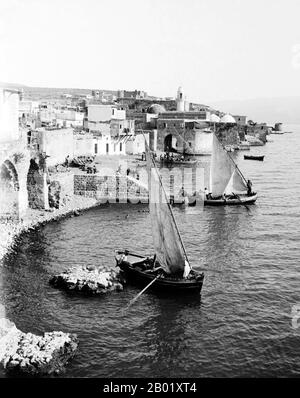 Palestine: Tiberias and Palestinian fishing boats by the shore of Lake Tiberias from the Greek Convent, 1928.  Palestine is a name given to the geographic region between the Mediterranean Sea and the Jordan River. The region is also known as the Land of Israel, the Holy Land and the Southern Levant.  In 1832 Palestine was conquered by Muhammad Ali's Egypt, but in 1840 Britain intervened and returned control of the Levant to the Ottomans in return for further capitulations. The end of the 19th century saw the beginning of Zionist immigration and the Revival of the Hebrew language. Stock Photo