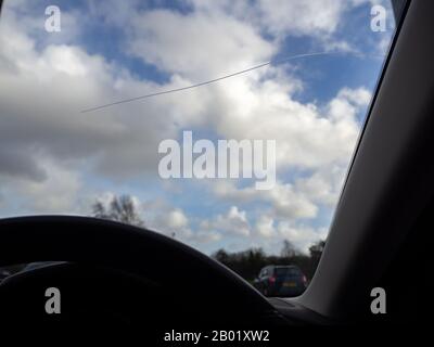 Single line of crack in car windscreen glass, cracked from the outside. Stock Photo