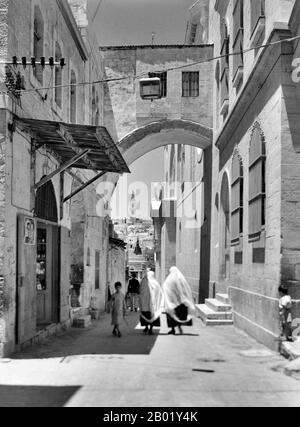 Palestine: Arch on the Via Dolorosa, Jerusalem, c. 1900-1920.  Palestine is a name given to the geographic region between the Mediterranean Sea and the Jordan River. The region is also known as the Land of Israel, the Holy Land and the Southern Levant.  In 1832 Palestine was conquered by Muhammad Ali's Egypt, but in 1840 Britain intervened and returned control of the Levant to the Ottomans in return for further capitulations. The end of the 19th century saw the beginning of Zionist immigration and the Revival of the Hebrew language. Stock Photo