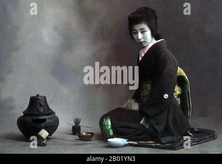 Japan: Kimono-clad woman preparing for the chanoyu Tea Ceremony, c. 1900.  The Japanese tea ceremony, also called the Way of Tea, is a Japanese cultural activity involving the ceremonial preparation and presentation of matcha, powdered green tea. In Japanese, it is called chanoyu or chadō, sadō. The manner in which it is performed, or the art of its performance, is called otemae. Zen Buddhism was a primary influence in the development of the tea ceremony.  Tea gatherings are classified as chakai or chaji. Stock Photo