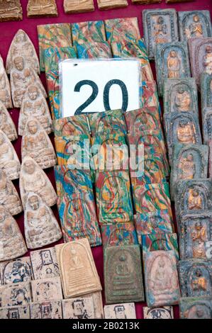 Thailand: Amulets for sale, Amulet Market next to Wat Mahathat, near Sanam Luang, Bangkok.  The Amulet Market next to Wat Mahathat in Bangkok is one of the city's best known places to buy Buddhist amulets and lucky charms. Vendors line the street with miniature Buddhas, astrological icons, pendants, phalluses, ivory, gems and other assorted paraphernalia for the religious, the superstitious and the curious.  Thailand's amulet trade is a lively one, and prices for particularly powerful amulets can run into millions of Baht. Stock Photo