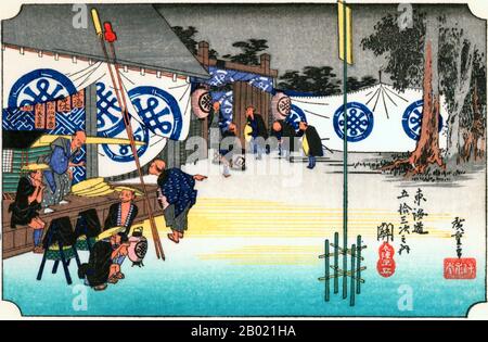 Seki: View outside a resthouse in the early morning, where a daimyo is stopping, the retainers preparing, by the aid of lanterns, to proceed on the journey.  Each station was required to maintain lodging houses for travellers. The inn shown is one for upper class travellers such as Shogunate officials and feudal lords.  Utagawa Hiroshige (歌川 広重, 1797 – October 12, 1858) was a Japanese ukiyo-e artist, and one of the last great artists in that tradition. He was also referred to as Andō Hiroshige (安藤 広重) (an irregular combination of family name and art name) and by the art name of Ichiyūsai Hiros Stock Photo