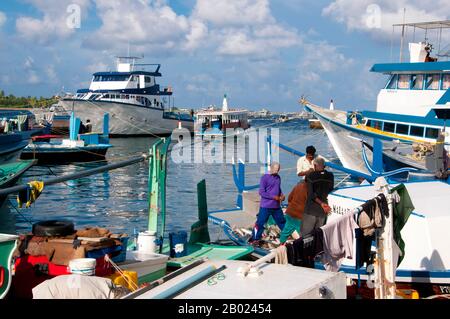 Asia's smallest and least-known nation, the Republic of Maldives, lies scattered from north to south across a 750-kilometre sweep of the Indian Ocean 500 kilometres south-west of Sri Lanka. More than 1000 islands, together with innumerable banks and reefs, are grouped in a chain of nineteen atolls which extends from a point due west of Colombo to just south of the equator.  The atolls, formed of great rings of coral based on the submarine Laccadive-Chagos ridge, vary greatly in size. Some are only a few kilometres square, but in the far south the great atoll of Suvadiva is sixty-five kilometre Stock Photo