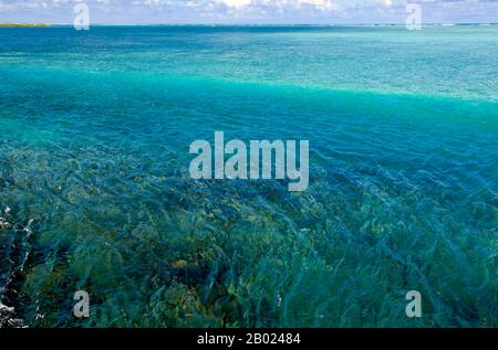 Asia's smallest and least-known nation, the Republic of Maldives, lies scattered from north to south across a 750-kilometre sweep of the Indian Ocean 500 kilometres south-west of Sri Lanka. More than 1000 islands, together with innumerable banks and reefs, are grouped in a chain of nineteen atolls which extends from a point due west of Colombo to just south of the equator.  The atolls, formed of great rings of coral based on the submarine Laccadive-Chagos ridge, vary greatly in size. Some are only a few kilometres square, but in the far south the great atoll of Suvadiva is sixty-five kilometre Stock Photo