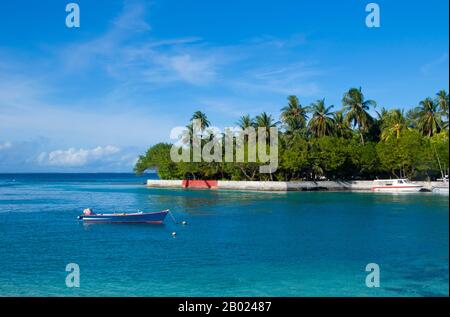 Asia's smallest and least-known nation, the Republic of Maldives, lies scattered from north to south across a 750-kilometre sweep of the Indian Ocean 500 kilometres south-west of Sri Lanka. More than 1000 islands, together with innumerable banks and reefs, are grouped in a chain of nineteen atolls which extends from a point due west of Colombo to just south of the equator.  The atolls, formed of great rings of coral based on the submarine Laccadive-Chagos ridge, vary greatly in size. Some are only a few kilometres square, but in the far south the great atoll of Suvadiva is sixty-five kilometre Stock Photo