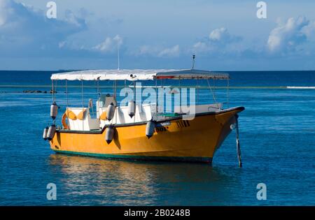 Asia's smallest and least-known nation, the Republic of Maldives, lies scattered from north to south across a 750-kilometre sweep of the Indian Ocean 500 kilometres south-west of Sri Lanka. More than 1000 islands, together with innumerable banks and reefs, are grouped in a chain of nineteen atolls which extends from a point due west of Colombo to just south of the equator.  The atolls, formed of great rings of coral based on the submarine Laccadive-Chagos ridge, vary greatly in size. Some are only a few kilometres square, but in the far south the great atoll of Suvadiva is sixty-five kilometre Stock Photo