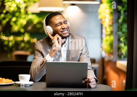 Young black businessman listening to music with headset Stock Photo