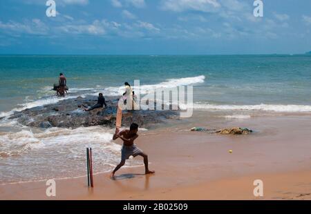 Sri Lanka: Cricket being played on the beach at Mount Lavinia, south of Colombo.  Cricket is the most popular sport in Sri Lanka. Sri Lanka is one of the ten nations that take part in test cricket and one of the five nations that has won a cricket world cup. Cricket is played at professional, semi-professional and recreational levels in the country and international cricket matches are watched with interest by a large proportion of the population.  Cricket was first brought to the island by the British and is believed to have first been played there around 1800. Stock Photo