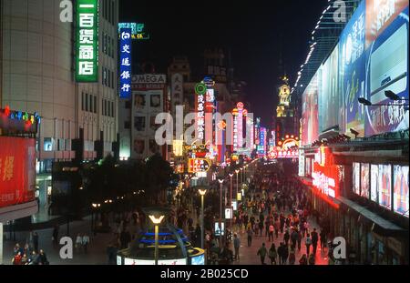 China: Neon lights on Nanjing Lu, Shanghai’s exclusive shopping avenue, (Walking Street), Shanghai.  Shanghai began life as a fishing village, and later as a port receiving goods carried down the Yangzi River. From 1842 onwards, in the aftermath of the first Opium War, the British opened a ‘concession’ in Shanghai where drug dealers and other traders could operate undisturbed. French, Italians, Germans, Americans and Japanese all followed. By the 1920s and 1930s, Shanghai was a boom town and an international byword for dissipation. Stock Photo