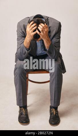 a young man holding his head. he is very concerned Stock Photo