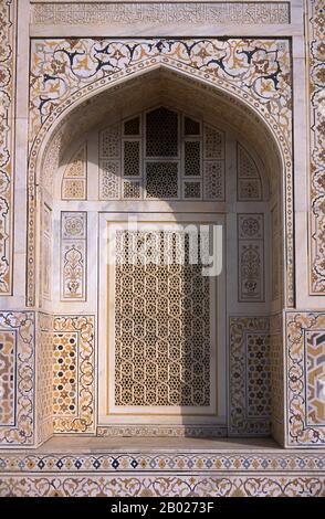 India: Window arch in the tomb of I'timad-ud-Daulah, Agra. Etimad-ud-Daula's Tomb is a Mughal mausoleum in the city of Agra in the Indian state of Uttar Pradesh.  Along with the main building, the structure consists of outbuildings and gardens. The tomb, built between 1622 and 1628 represents a transition between the first phase of monumental Mughal architecture - primarily built from red sandstone with marble decorations, as in Humayun's Tomb in Delhi and Akbar's tomb in Sikandra - to its second phase, based on white marble and pietra dura inlay, most elegantly realized in the Taj Mahal. Stock Photo