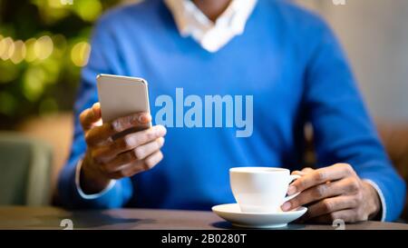 Close up of young man using his cell phone Stock Photo