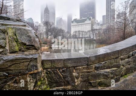 Gapstow Bridge in Central Park  on rainy wet day foggy