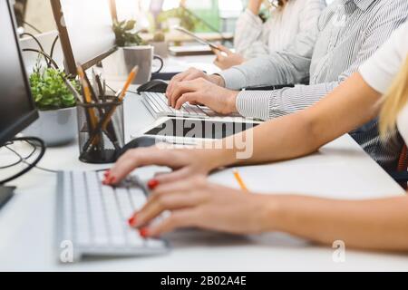 Cropped of people hands typing on keyboard, using digital tablet Stock Photo