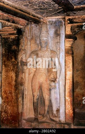 Ravana Phadi cave temple is one of the oldest rock cut temples in Aihole and dates back to the 6th century CE. It is dedicated to the Hindu god Shiva. The cave contains a Shivalinga in the inner room or sanctum sanctorum. The sanctum has a vestibule with a triple entrance and has carved pillars. The walls and sides of the temple are covered with large figures including a figure of Nataraja (Shiva) dancing, surrounded by the Saptamatrikas (Seven Mothers). Stock Photo