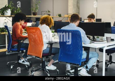 Young creative team working on business project at coworking space Stock Photo