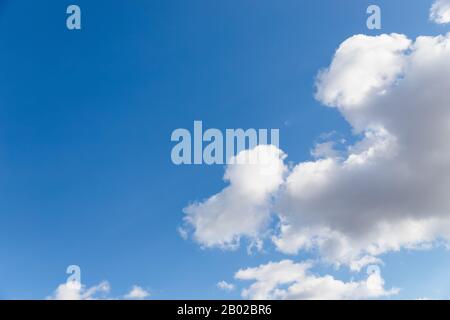 Scenic sky. Beautiful white soft fluffy clouds on a blue sky background Stock Photo