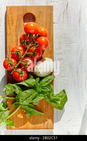 mozzarella, organic cherry tomatoes and fresh basil Stock Photo
