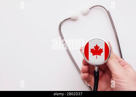 Canada healthcare concept. Doctor holding a medical stethoscope. Stock Photo